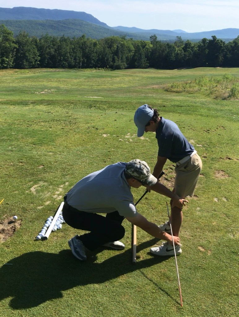 Henry Fall gives a junior golf lesson as the first assistant professional at Sugarloaf Golf Club in Maine.