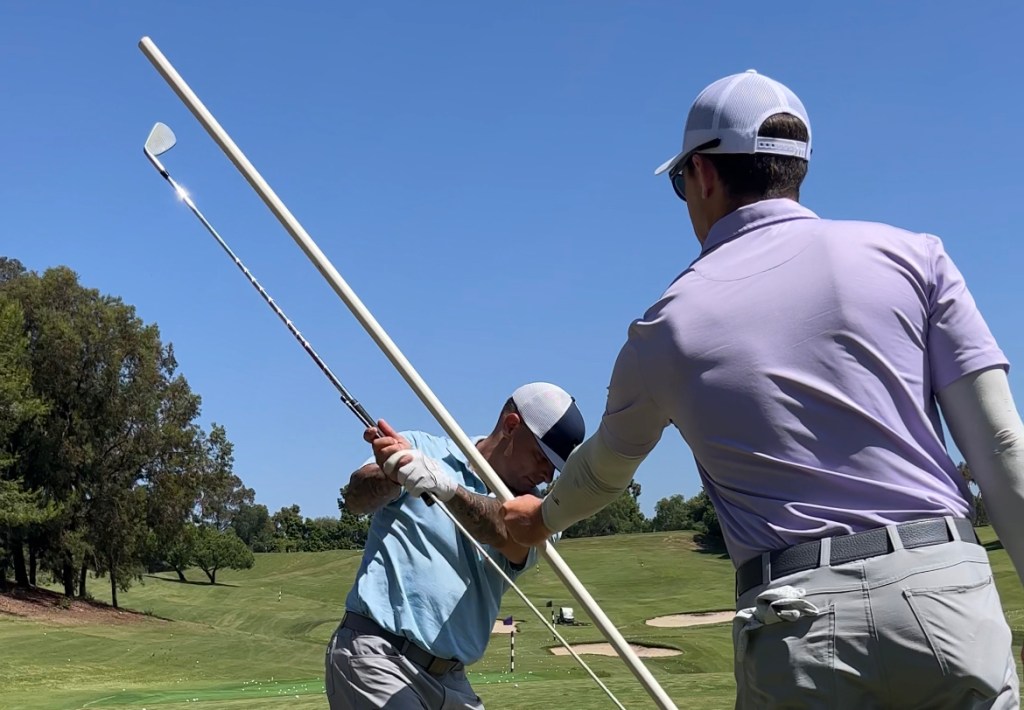 Henry Fall gives a downswing golf lesson while at a Milo Lines Golf School in San Diego, California.