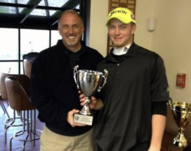 Henry Fall celebrating a division III college golf tournament win while attending Elms College.